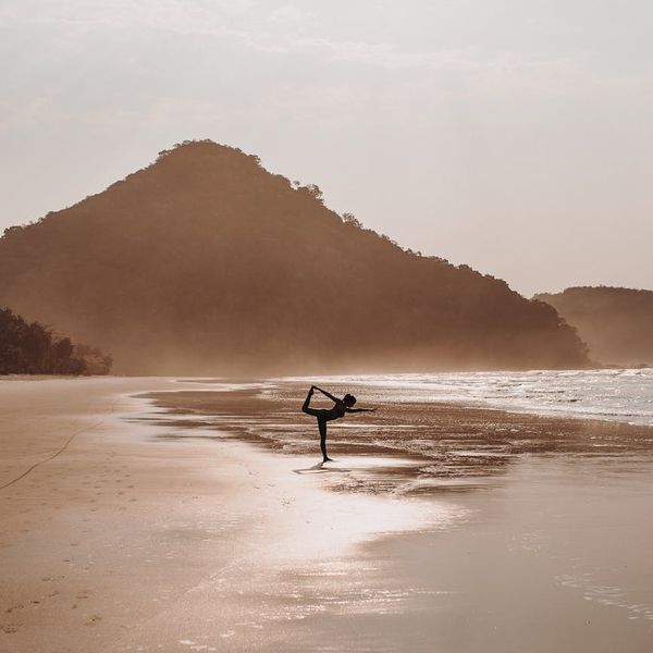 Woman in a serene yoga pose, embodying peace and balance.